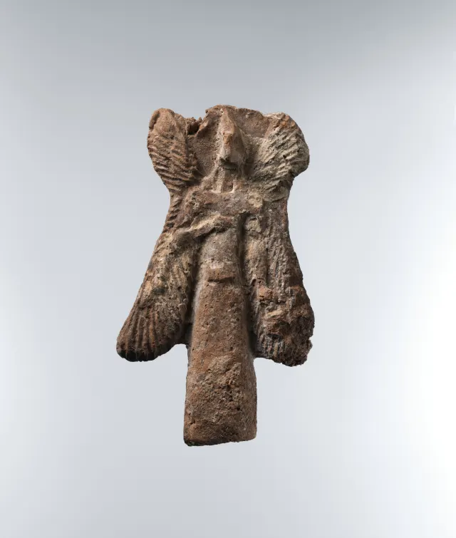 Apkallu figure: bird-headed, winged figure carrying a bucket